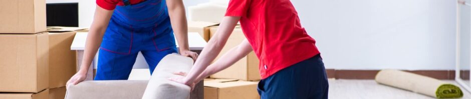 Newark NJ movers carrying packed boxes from a house